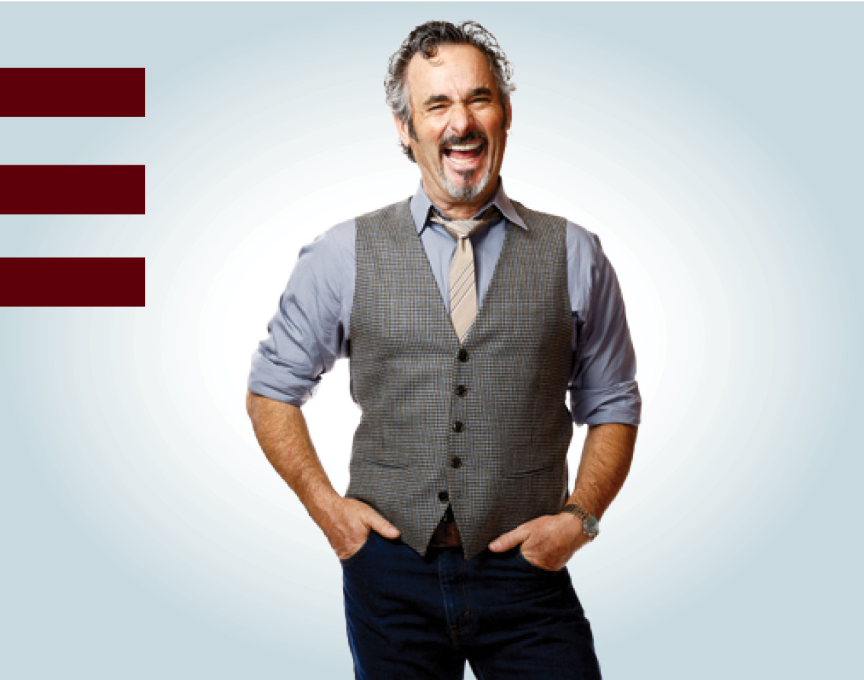 Photo of David Feherty laughing with MSU grounding bars in background.