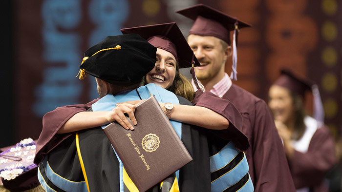 Graduates hugging